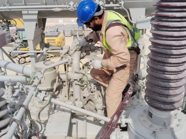 Technician working on substation electrical infrastructure