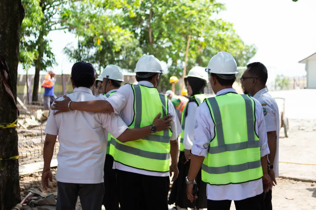 Site team in safety vests during a briefing