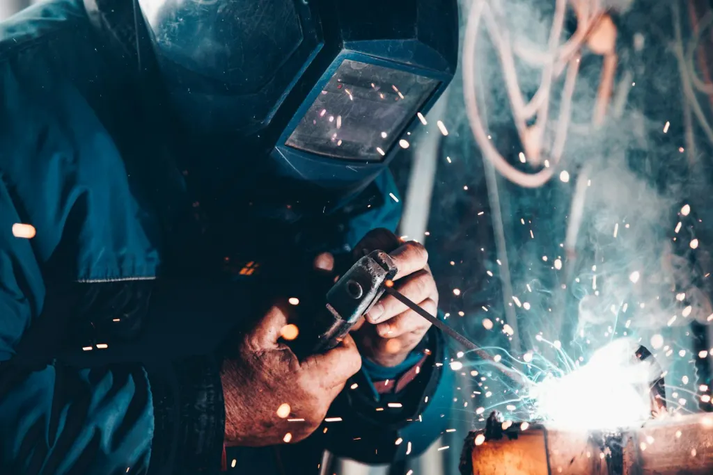 Welder working safely with PPE on site